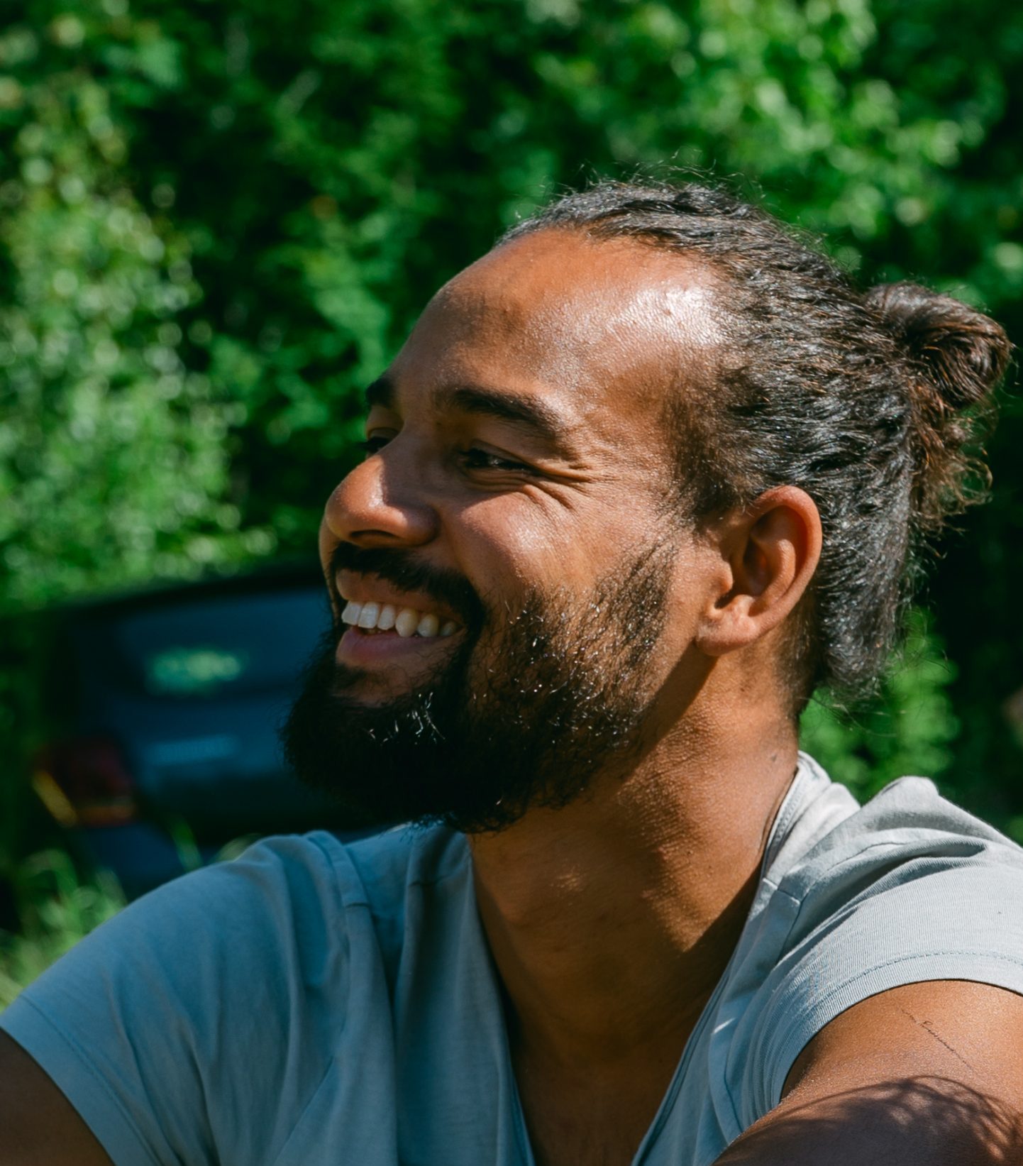 A Dutch man volunteering at a property in the lush Swedish woods, smiling and having a great time.