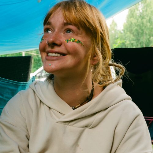 Happy volunteer with face make-up and glitter