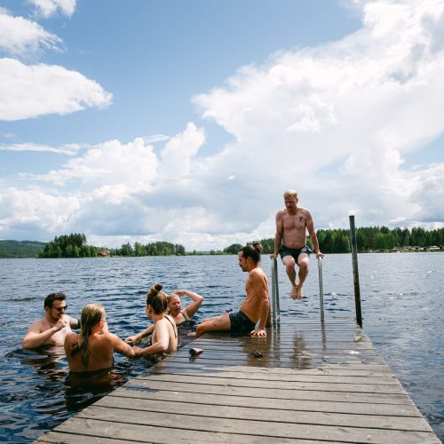 A group of volunteers enjoying a swim in the lake in the Swedish woods